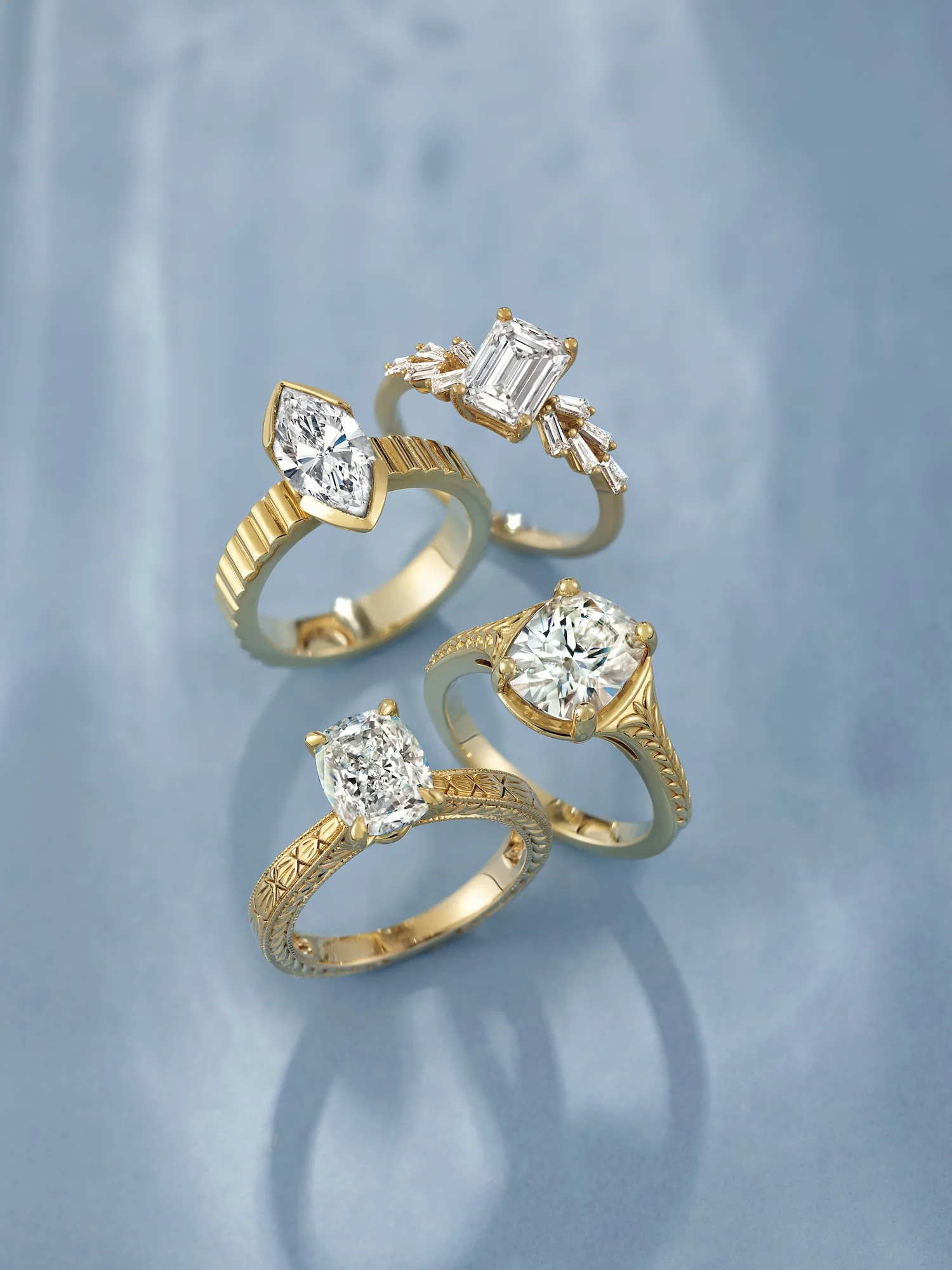 Four unique custom gold diamond rings with different cuts and settings