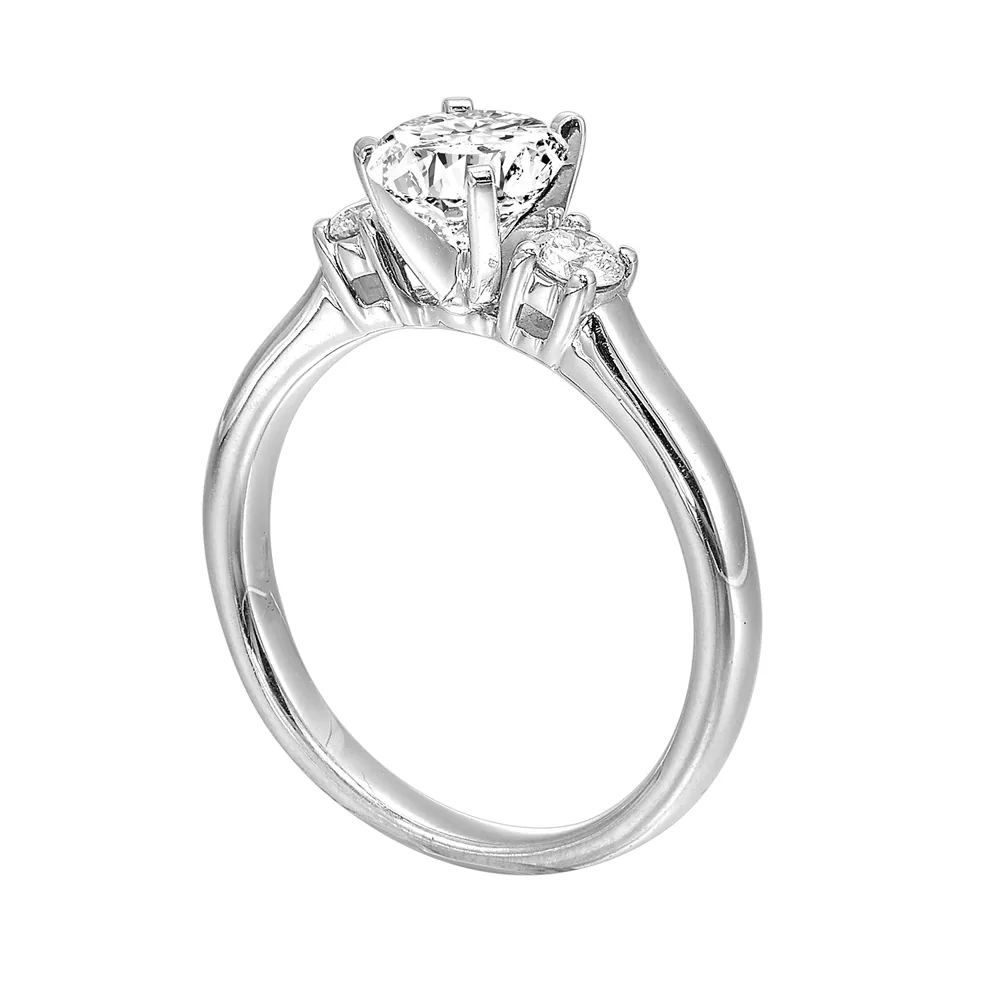 Classic and romantic, this three stone engagement ring features the bold gold shank to sparkle your moments further. view 3