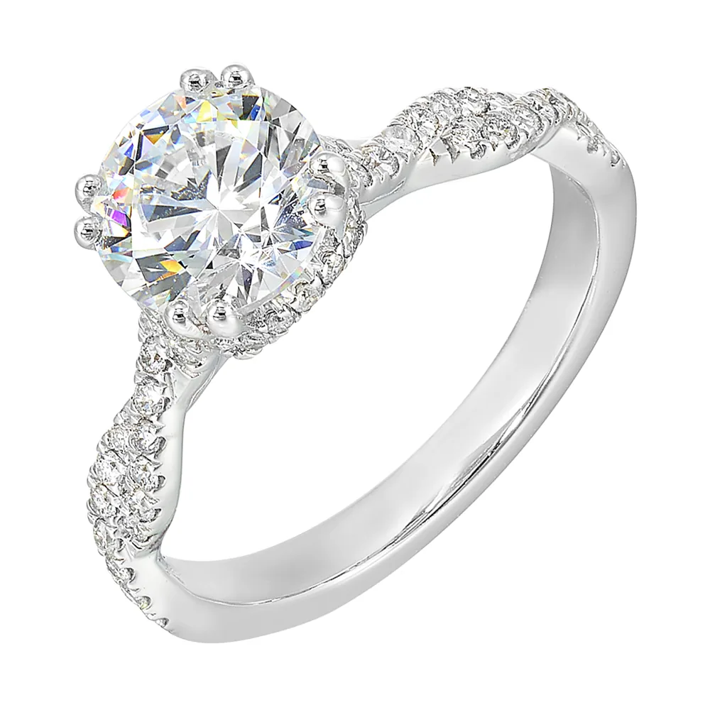 Stunning with a round solitaire diamond set in dual prongs atop a modern crisscross band. The unique twist on timeless elegance is perfect for the modern bride. view 2