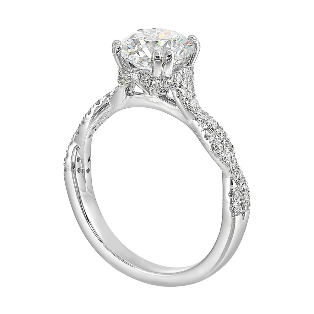 Stunning with a round solitaire diamond set in dual prongs atop a modern crisscross band. The unique twist on timeless elegance is perfect for the modern bride. view 3