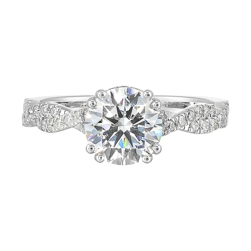 Stunning with a round solitaire diamond set in dual prongs atop a modern crisscross band. The unique twist on timeless elegance is perfect for the modern bride.